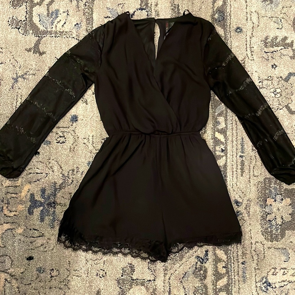 Black short romper with lace sleeves and lace detail